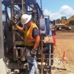 Prairie State Water technician inspects a drill before a well pump installation