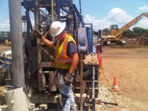 Prairie State Water technician inspects a drill before well pump installation